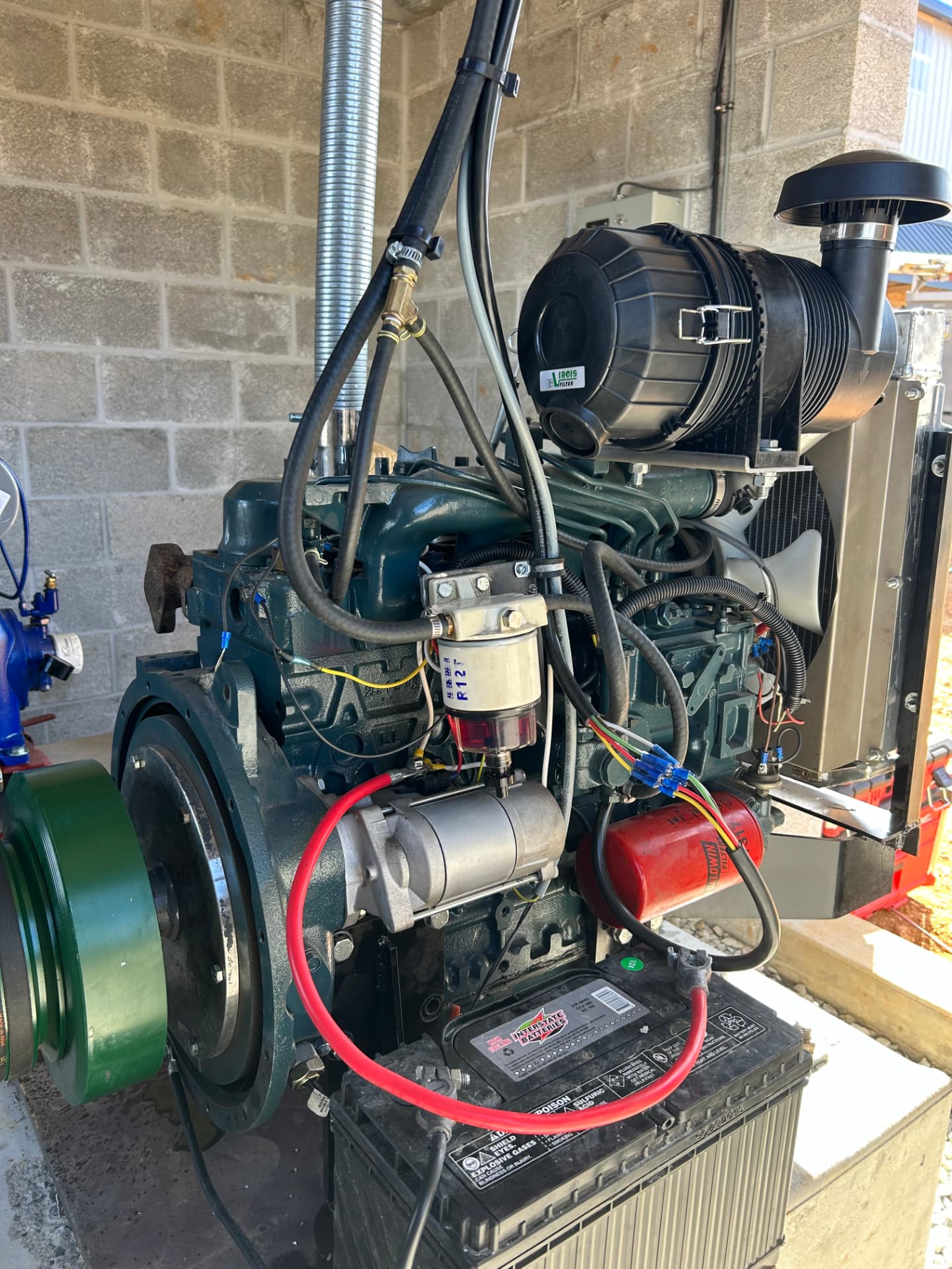 Freshly rebuilt diesel engine with new battery, air cleaner, and wiring at the Jaco Diesel & Equipment shop in Airville, Pennsylvania