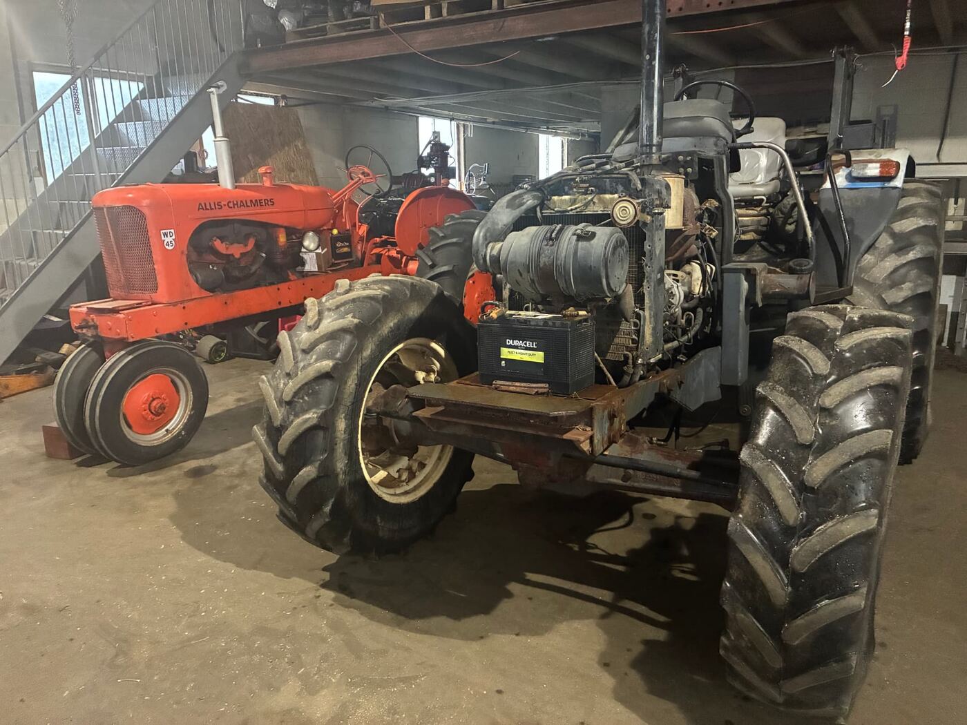 Tractor with its diesel engine opened up for repair inside the Jaco Diesel shop in Airville, PA