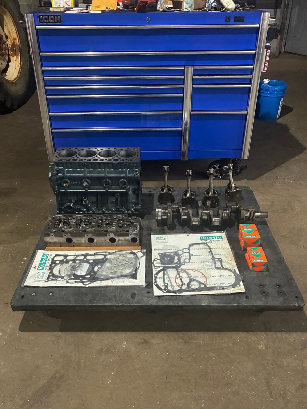 Kubota diesel engine rebuild parts staged in front of the shop toolbox